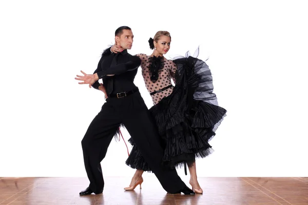 Latino dancers in ballroom against white background — Stock Photo, Image