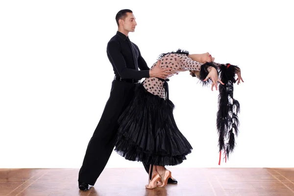 Latino dancers in ballroom against white background — Stock Photo, Image