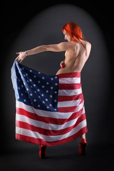 Mulher segurando uma bandeira americana — Fotografia de Stock