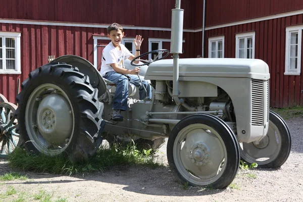 Pojke på vintage traktor — Stockfoto