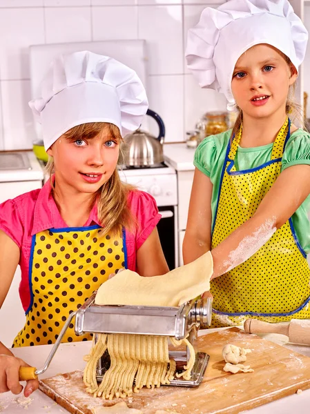 Kids in hat making homemade pasta at kitchen. — Stock Photo, Image