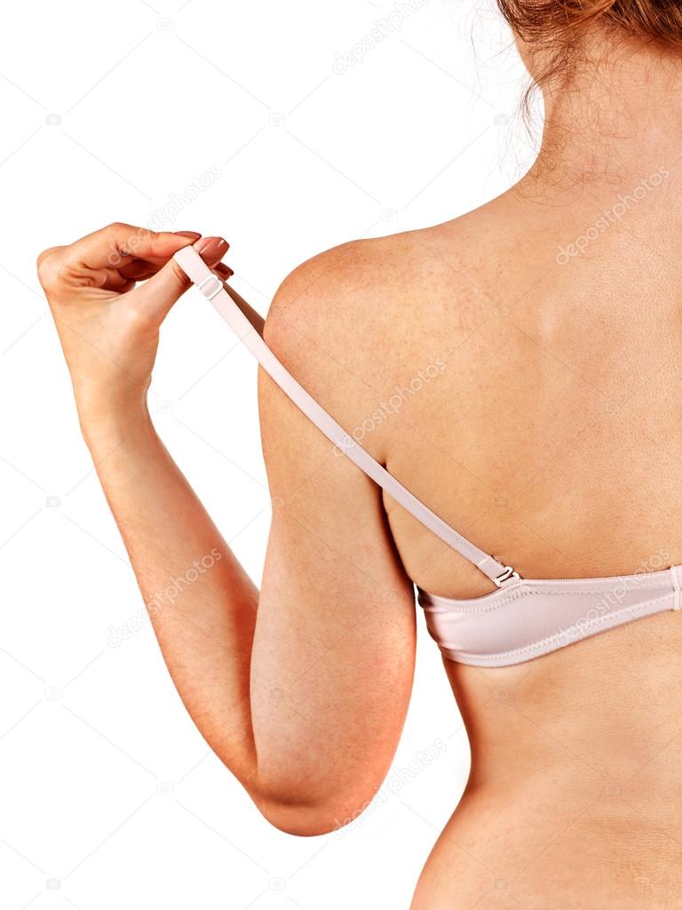 Girl removes underwear to examine their breasts. Breast self exam concept.