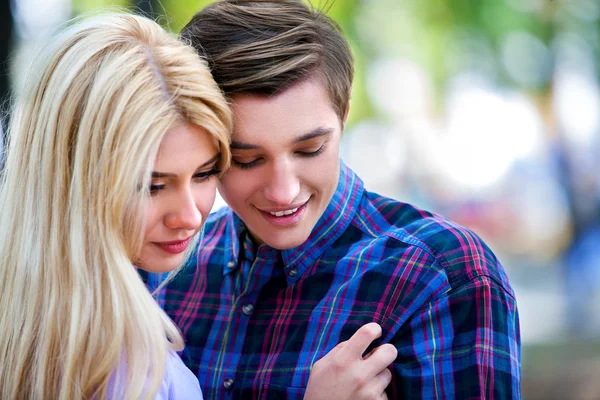 Pareja joven abrazándose y coqueteando en el parque . — Foto de Stock