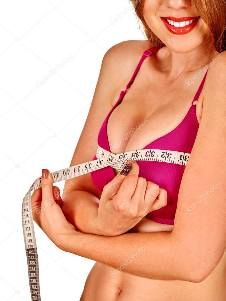 Girl in lingerie measures her breast measuring tape. Stock Photo by  ©poznyakov 102798906