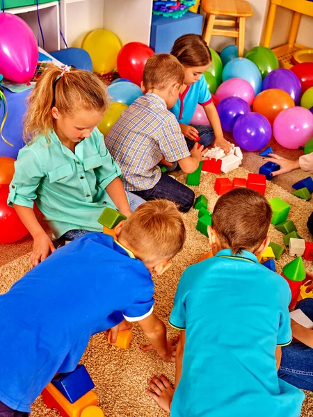 Ομάδα παιδιών παιχνίδι μπλοκ στο πάτωμα. Τα παιδιά παίζουν στην παιδική λέσχη. — Φωτογραφία Αρχείου