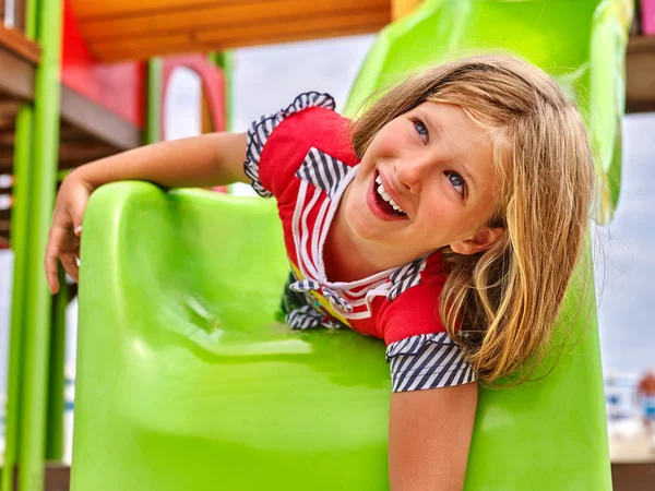Child girl upside down slippery dip on playground . — Stock Photo, Image