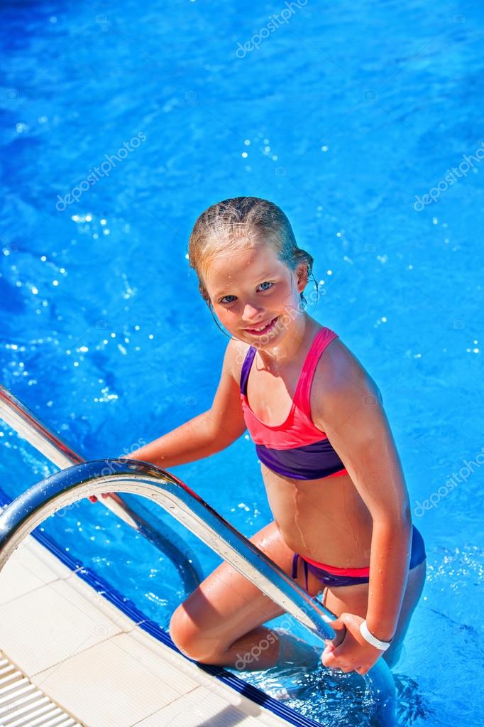 Child girl coming out of swimming pool . Stock Photo by ©poznyakov