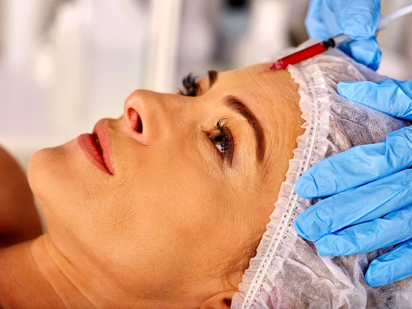 Woman middle-aged in spa salon with beautician. Woman giving botox injections. — Stock Photo, Image