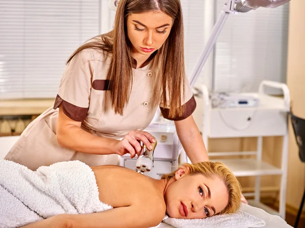 Woman receiving electroporation back therapy at beauty salon. — Stock Photo, Image