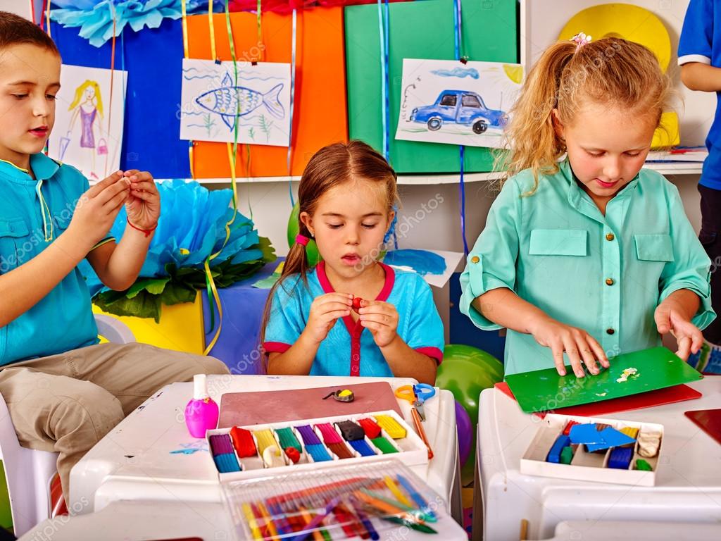 Plasticine Modeling Clay In Children Class. Teacher Teaches Kids Together  Play Dough And Mold From Plasticine In Kindergarten Or Preschool. Group Of  Four People. Zoo From The Clay. Stock Photo, Picture and