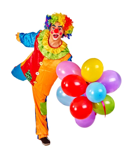 Feliz cumpleaños payaso sosteniendo un montón de globos . — Foto de Stock