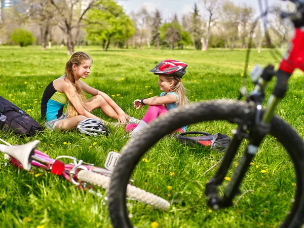 Bicycle girls wearing helmet. They have rest from cycling.