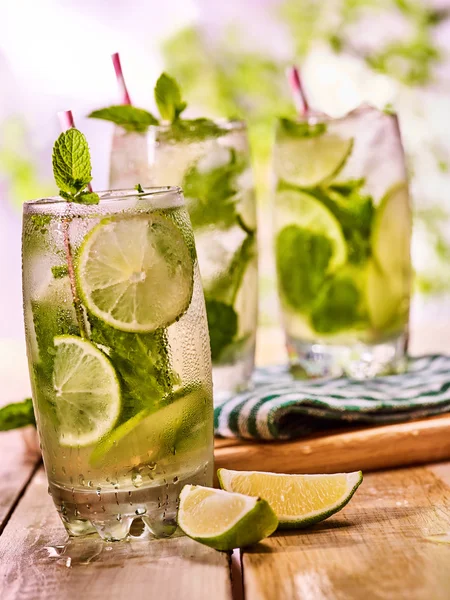 Sobre tablas de madera hay vasos con mohito y cuchillo . — Foto de Stock