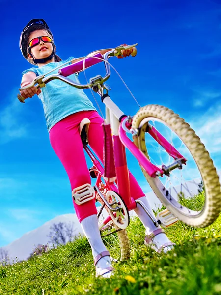 Bicicletas bicicleta menina vestindo capacete passeios de bicicleta . — Fotografia de Stock