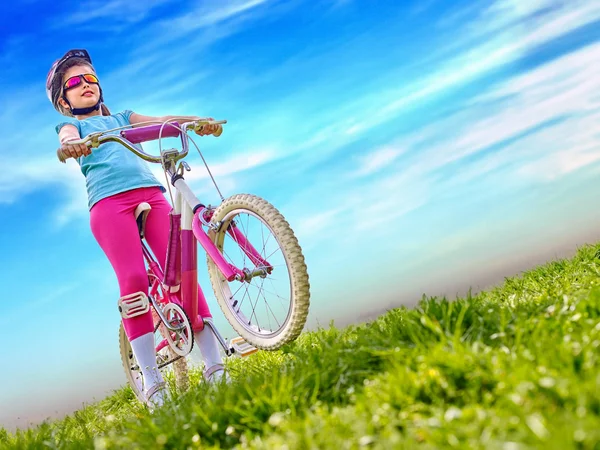 Bicicletas ciclismo menina vestindo capacete passeios de bicicleta . — Fotografia de Stock