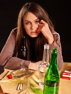Girl in depression drinking alcohol. clipart
