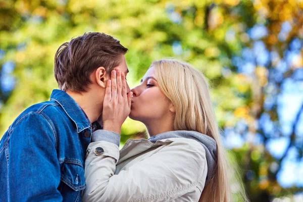 Jong koppel knuffelen en flirten in park. — Stockfoto