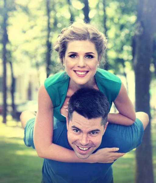 In love guy holding girl in his arms. — Stock Photo, Image