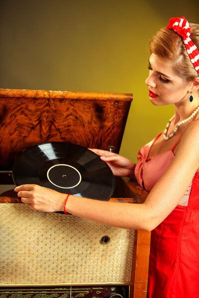 Girl in style keeps vinyl record.