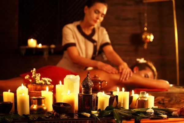 Mujer acostada en una cama spa de masaje de madera . — Foto de Stock