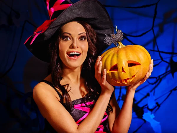 Witch holding pumpkin on Halloween party. — Stock Photo, Image