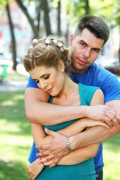 In love guy holding girl in his arms. — Stock Photo, Image