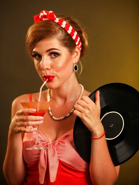 Girl pin-up style keeps vinyl record drink martini cocktail . — Stock Photo, Image