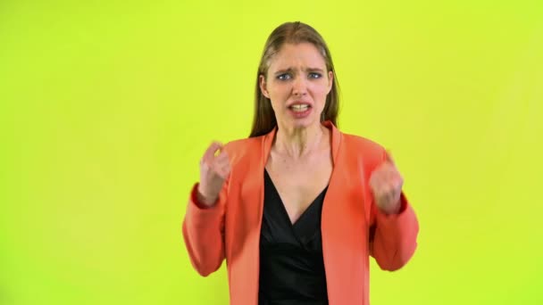 Woman in stress hysterical screaming, clenches fists yellow space studio — Stock Video