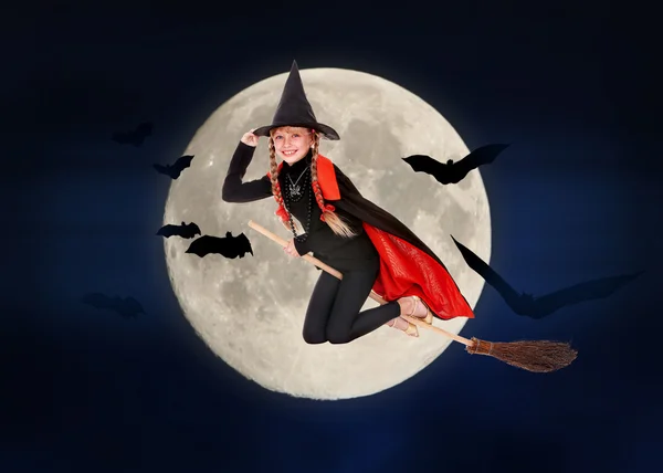 Child witch flying on broomstick — Stock Photo, Image