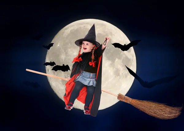 Child witch flying on broomstick — Stock Photo, Image