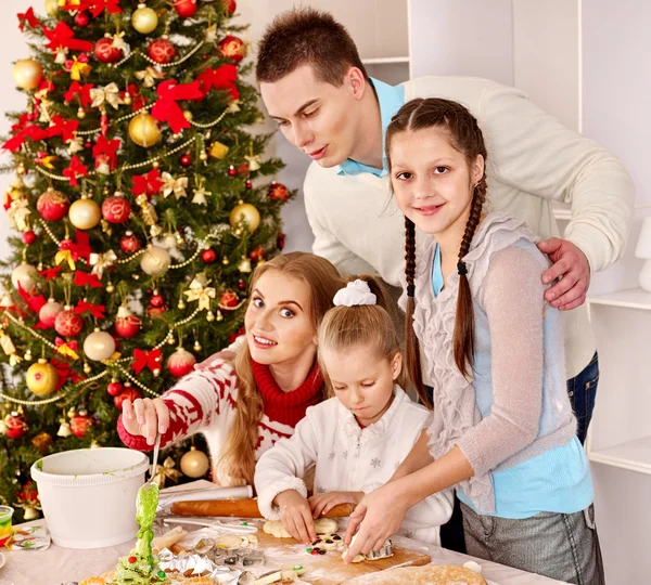 Family rolling dough in kitchen Stock Image