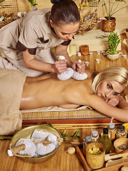 Woman getting herbal ball massage  . — Stock Photo, Image