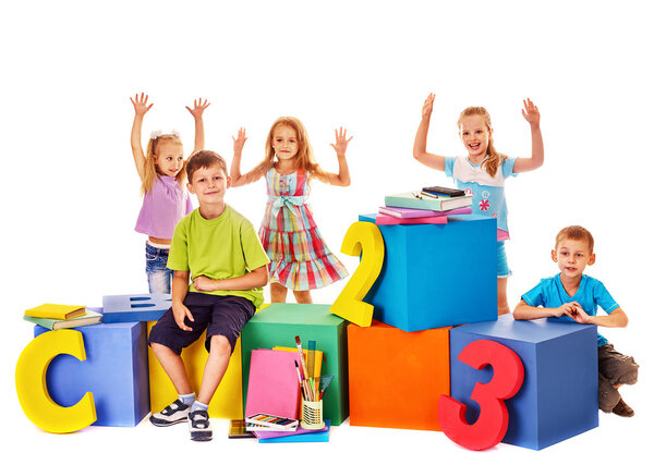 Children sitting at cube.