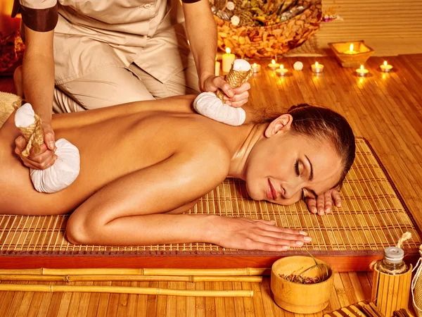 Woman getting herbal ball massage  . — Stock Photo, Image