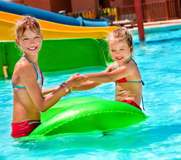 Children sitting on inflatable ring. — Stock Photo, Image