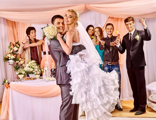 Groom  carries bride on his hands . — Stock Photo, Image