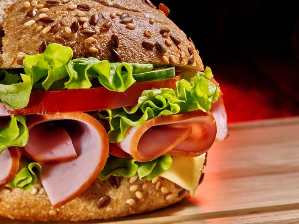 Hamburguesa con jamón sobre tabla de madera  . —  Fotos de Stock