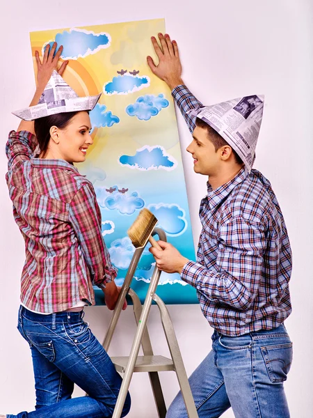 Family glues wallpaper at home. — Stock Photo, Image