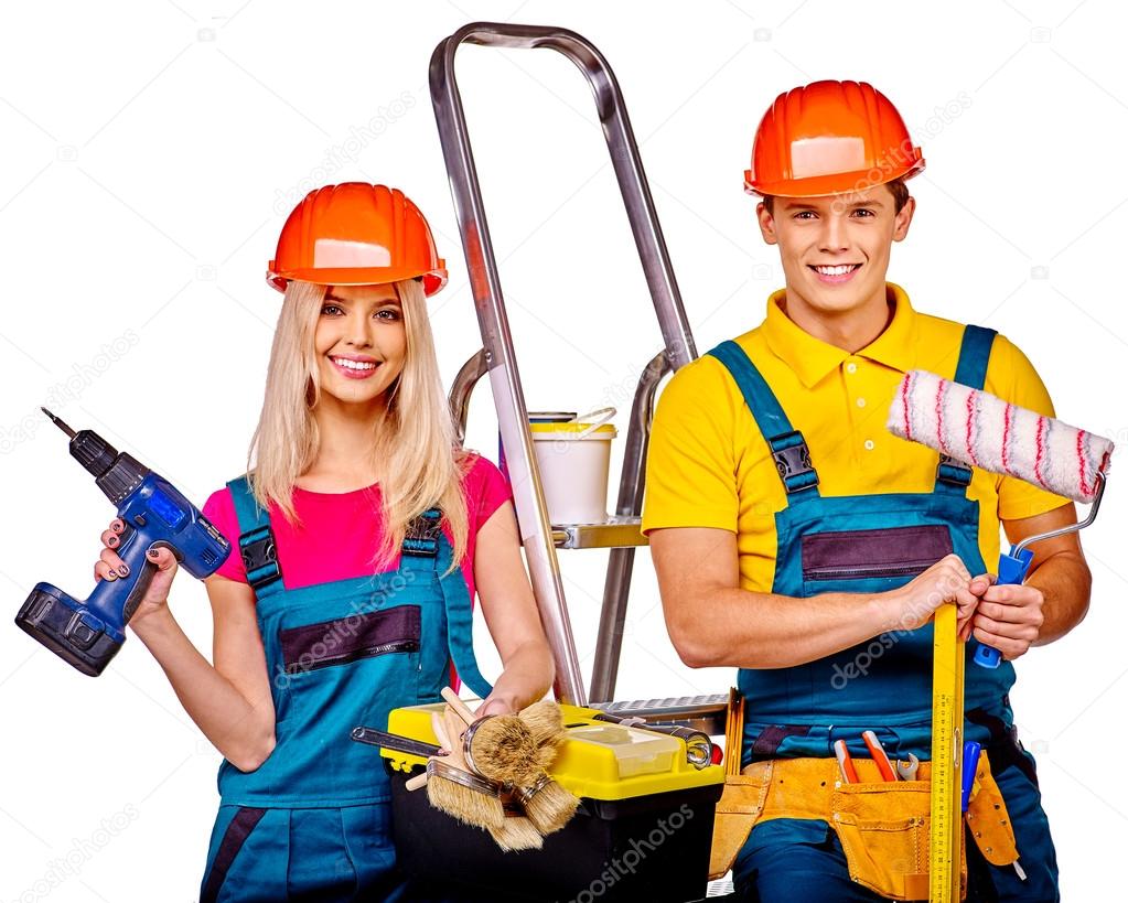 Couple builders  with construction tools.