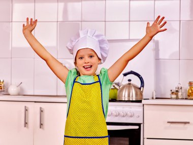 Child cooking at kitchen. clipart