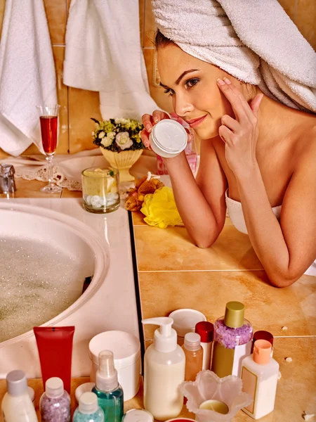 Woman applying moisturizer. Royalty Free Stock Images