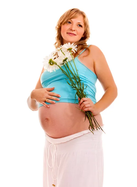 Pregnant woman with flowesr. — Stock Photo, Image