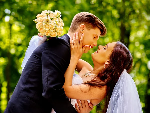 Groom kissing bride. — Stock Photo, Image