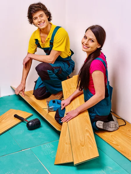 Family laying parquet at home — Stock Photo, Image