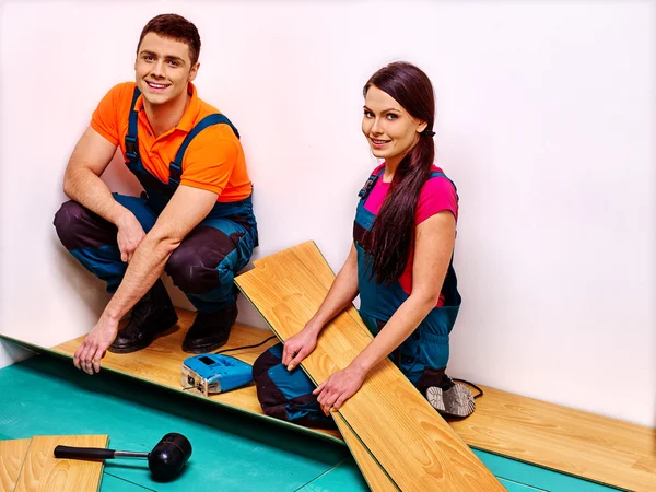 Family laying parquet at home. — Stock Photo, Image