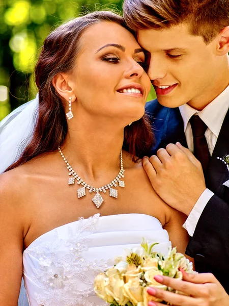 Groom embracing bride — Stock Photo, Image