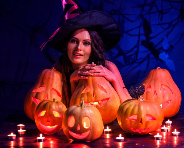 Witch woman with pumpkins — Stock Photo, Image