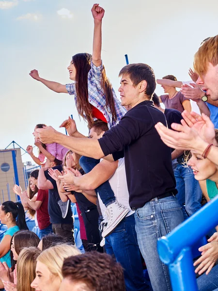 Sport fans hands up and singing  on tribunes. — Stock Photo, Image