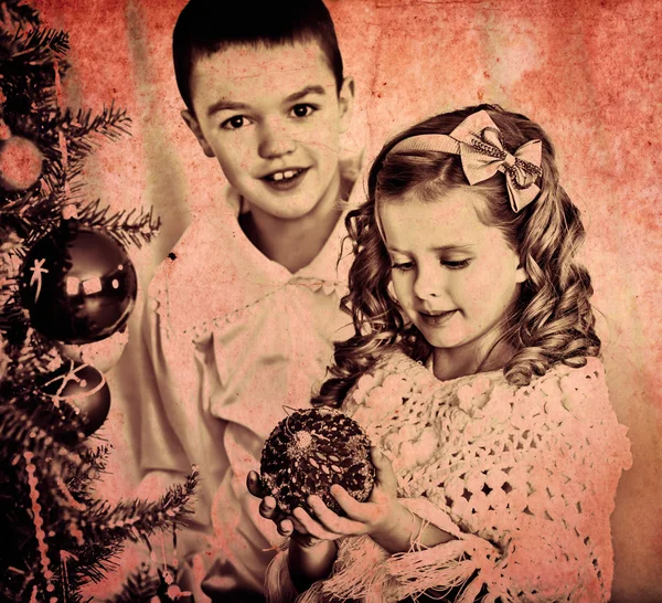 Children decorate on Christmas tree. — Stock Photo, Image