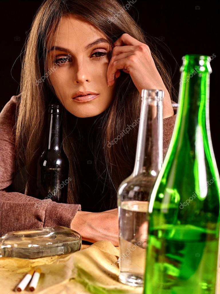 Drunk girl holding bottle of vodka. Stock Photo by ©poznyakov 89214694